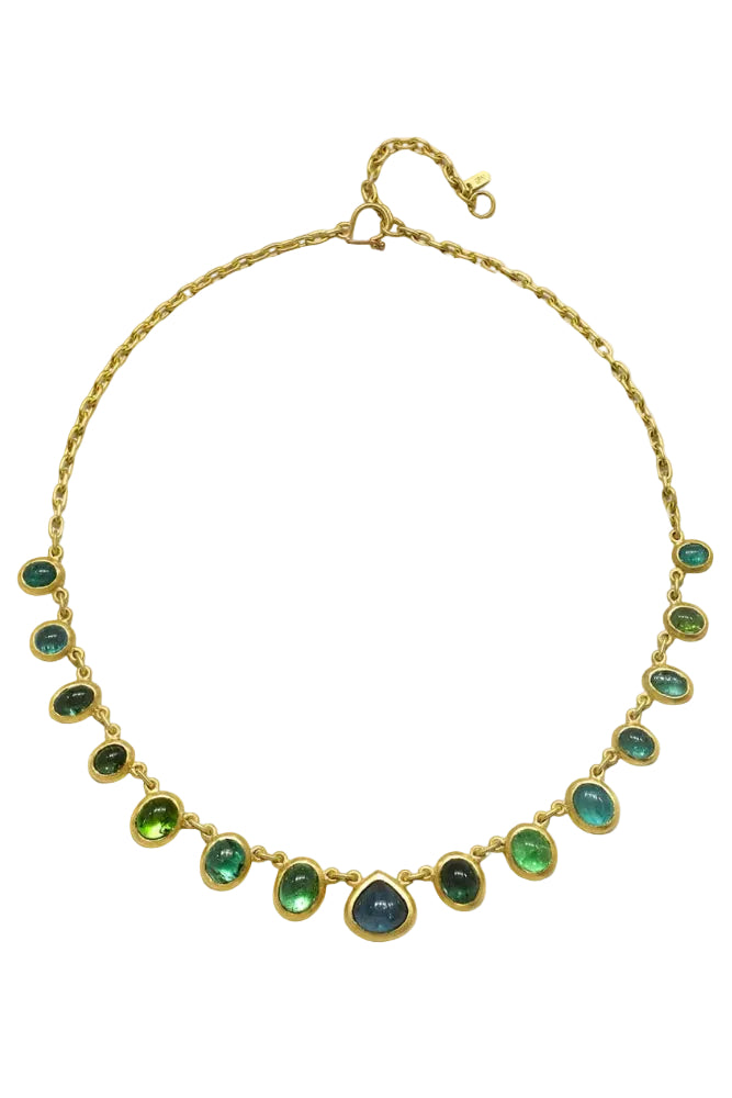 14kGold necklace with green gemstones on a white background